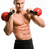 Man performing interval training with kettlebells