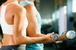 Man and woman lifting weights together