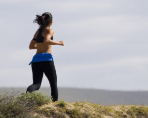 Young woman jogging on the beach