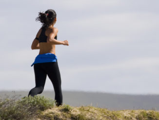 Young woman jogging on the beach