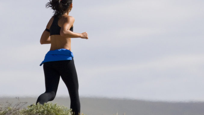 Young woman jogging on the beach