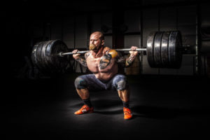 Man squatting massive amount of weight